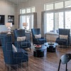 lounge room with ample, comfortable easy-chairs and couches and spacious room for movement or socializing